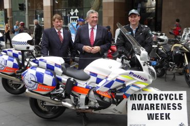 NSW MCC vice-chairman Chris Burns (left), NSW Transport Minister Duncan Gay and police officer - helmet legal issue