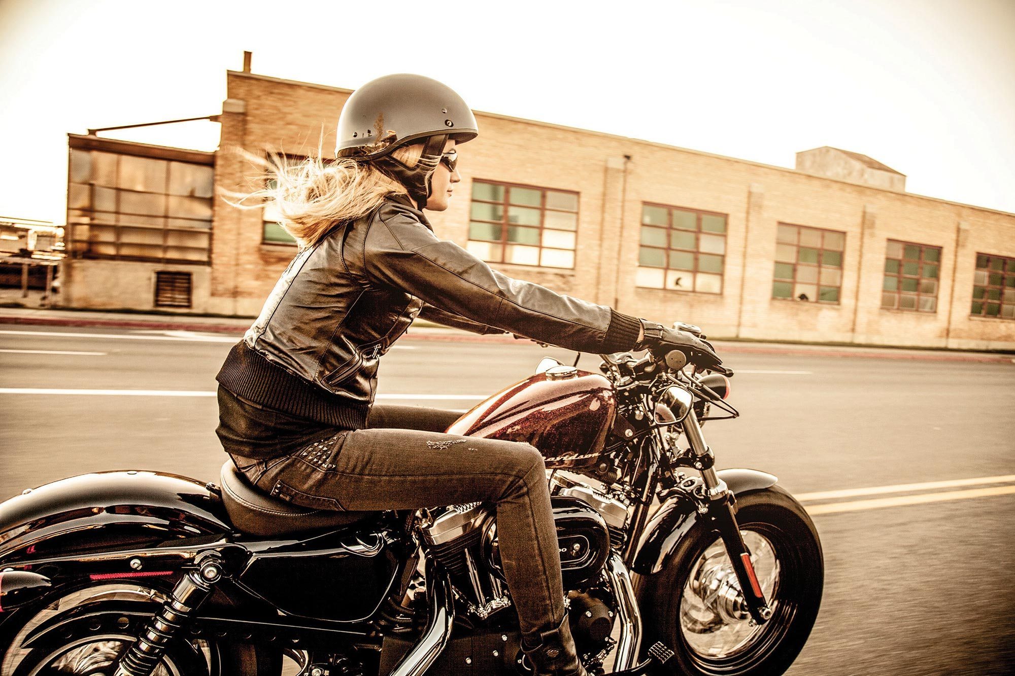 Woman riding Harley Davidson Motorcycle in Industrial Area