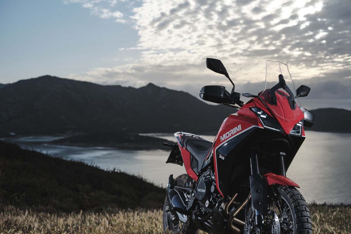A view of the all-new Moto Morini X-Cape adventure motorbike on rugged terrain, with a gorgeous tropical view.