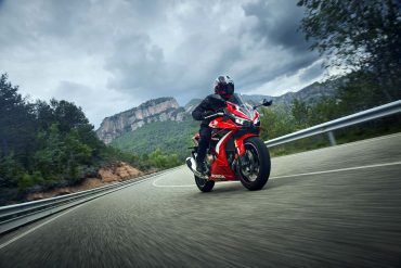 A view of a rider enjoying the new 2022 Honda CBR500R in Grand Prix Red