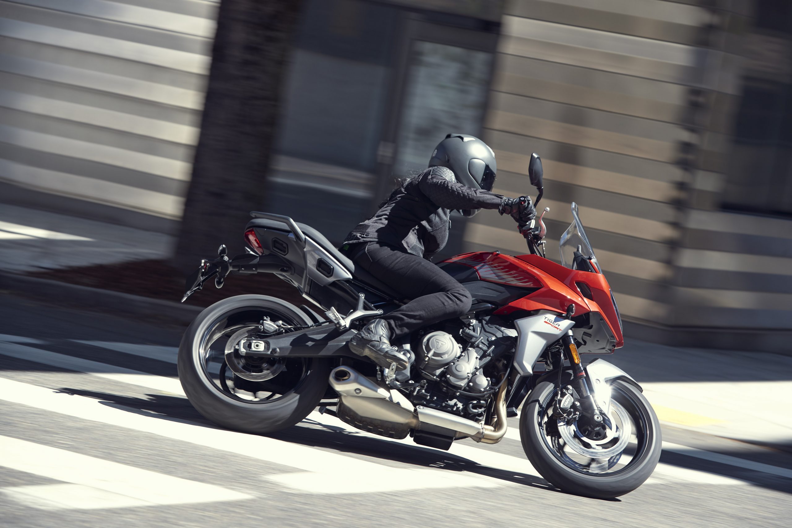 A shot of a rider cornering on the new Triumph Tiger Sport 660 in the city