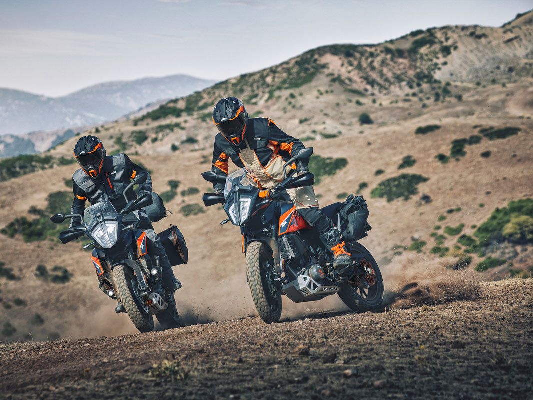 A shot of two KTM 390 Adventures' riding through the dirt