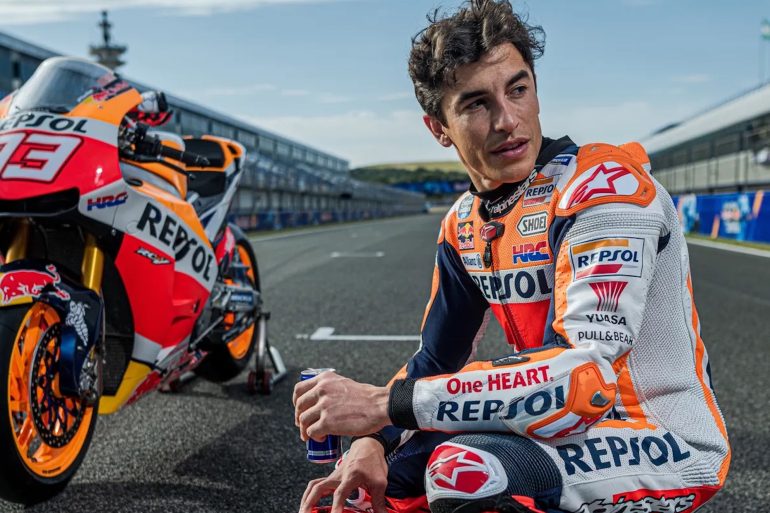 Marc Marquez with his Honda racebikje in the background. Media sourced from The Guardian.